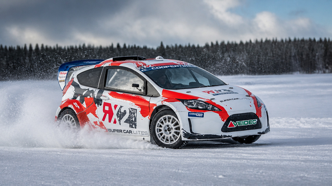 Rallye-Auto fährt mit hoher Geschwindigkeit auf verschneiter Winterstrecke, Schnee spritzt hinter den Reifen auf.